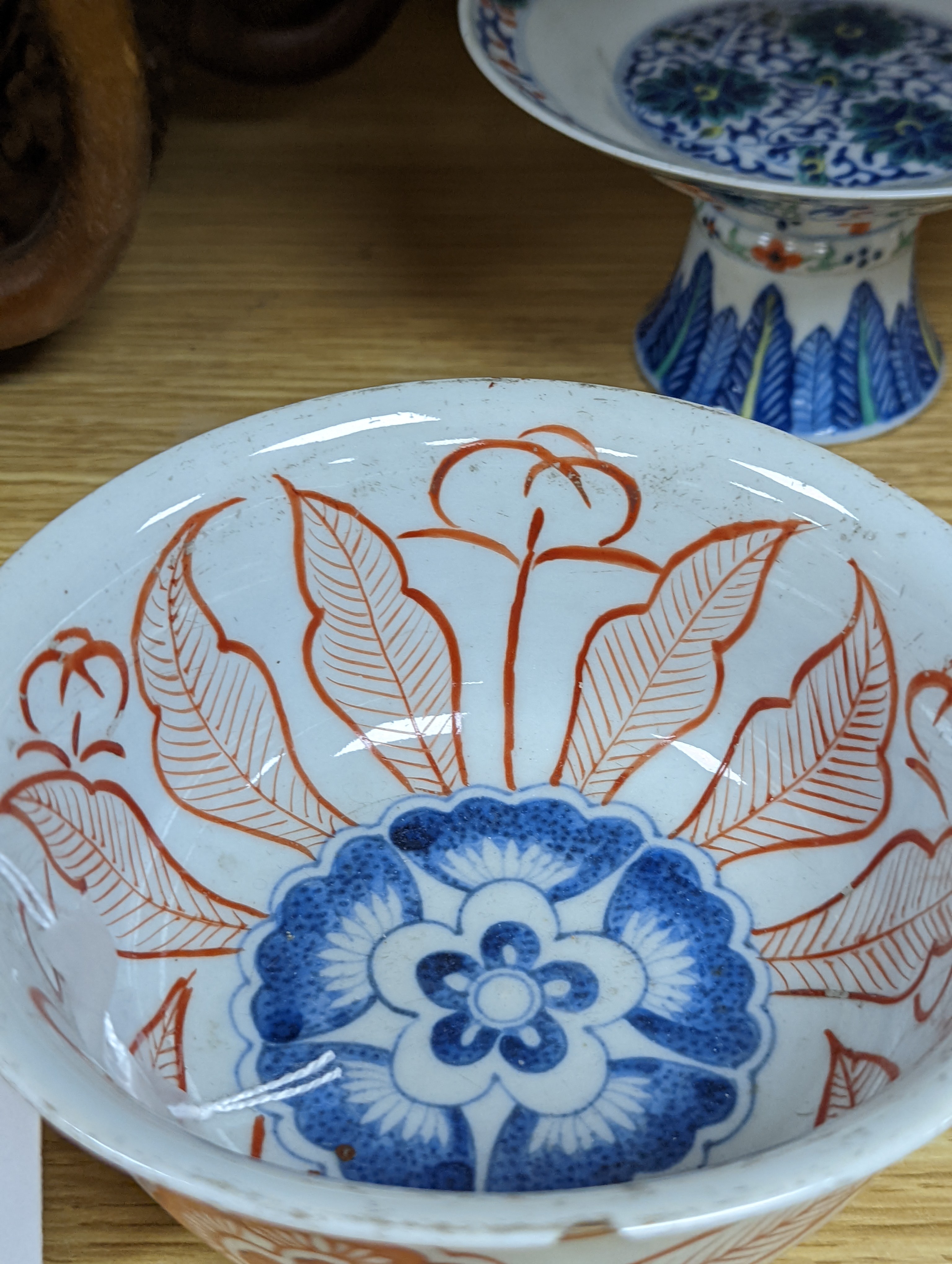 A Chinese blue and white water pipe vessel, a doucai stem dish and a Japanese Imari bowl, 19th century, (3)